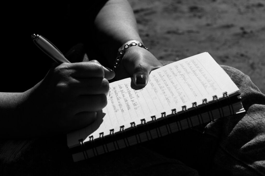 Close-up of a person writing in a notebook, captured in Mar del Plata, Argentina.