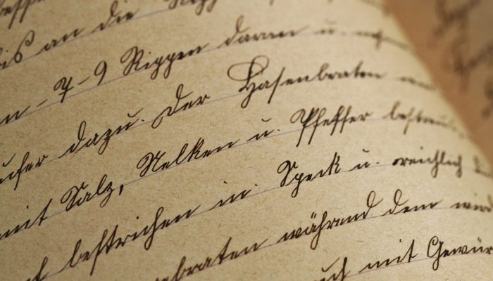 texture handwriting sutterlin vintage 99562 99562 Close-up of vintage handwriting on antique aged paper with sepia tones.